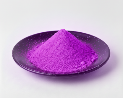 Purple powder on a black plate with a white background