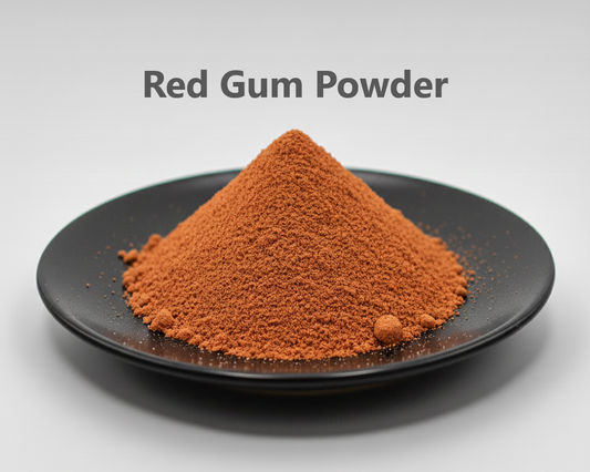 Red gum powder on a black plate with a gray background