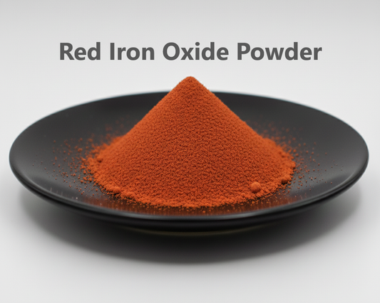 Red iron oxide powder on a black plate with a gray background